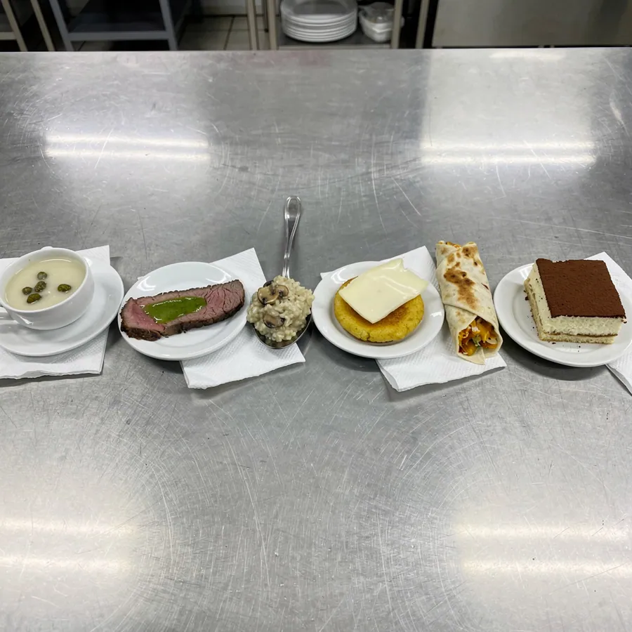 Six tasting portions on stainless kitchen counter Six tasting portions on stainless kitchen counter